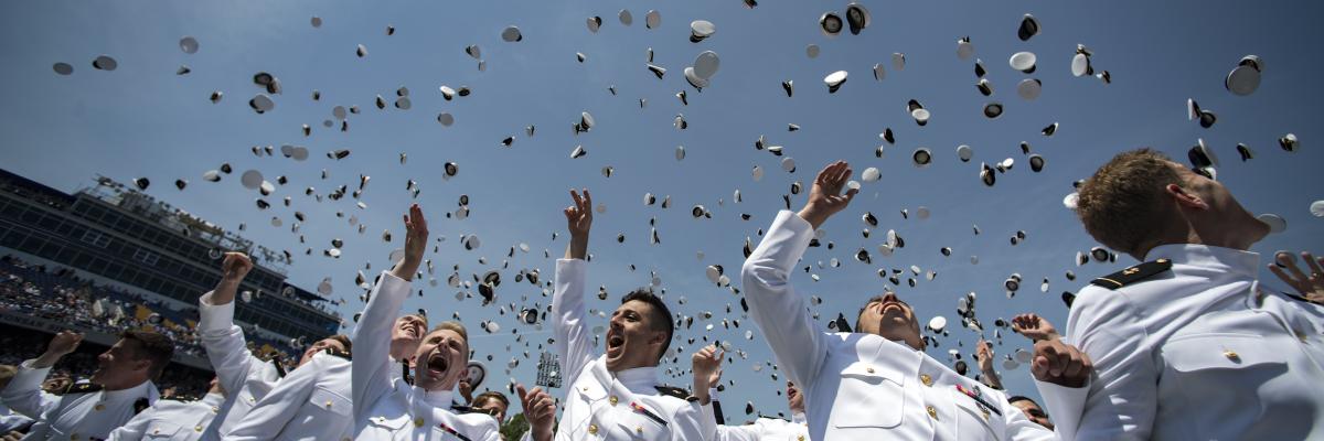Newly-Commissioned ensigns at the U.S. Naval Academy throwing their hats into the air at commencement.