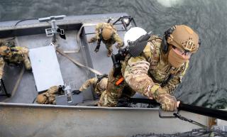 Republic of Korea (ROK) Navy personnel board a merchant ship