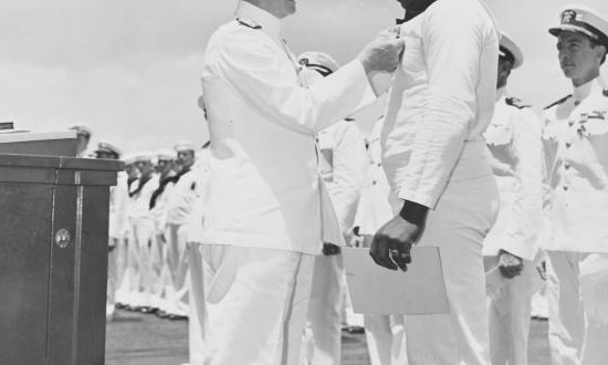 Admiral Chester Nimitz (left) awards the Navy Cross to Messman Third Class Doris “Dori” Miller.