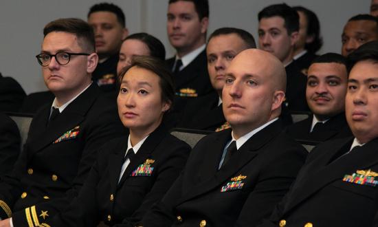 Department heads listen to a speaker 