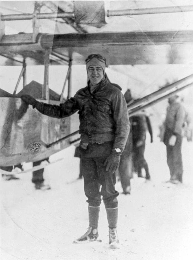 Lieutenant Commander Barnaby standing with his glider that’s attached to the airship USS Los Angeles (ZR-3), NAS Lakehurst, NJ, January 31st, 1930.