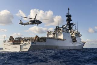 A Navy MH-60S Seahawk helicopter conducts touch-and-go drills