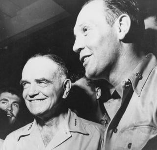 Halsey enjoys a joke with Commander Joseph C. Clifton