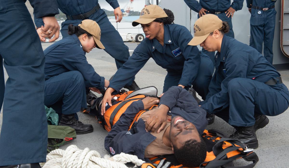 USS Blue Ridge (LCC-19) sailors secure an injured sailor